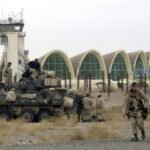 U.S. Marines patrol near the runway of the Kandahar International Airport 15 December, 2001. The Marines took control of the airport before dawn 14 December. AFP PHOTO   AP POOL/DAVE MARTIN (Photo by DAVE MARTIN / AP POOL / AFP) (Photo by DAVE MARTIN/AP POOL/AFP via Getty Images)